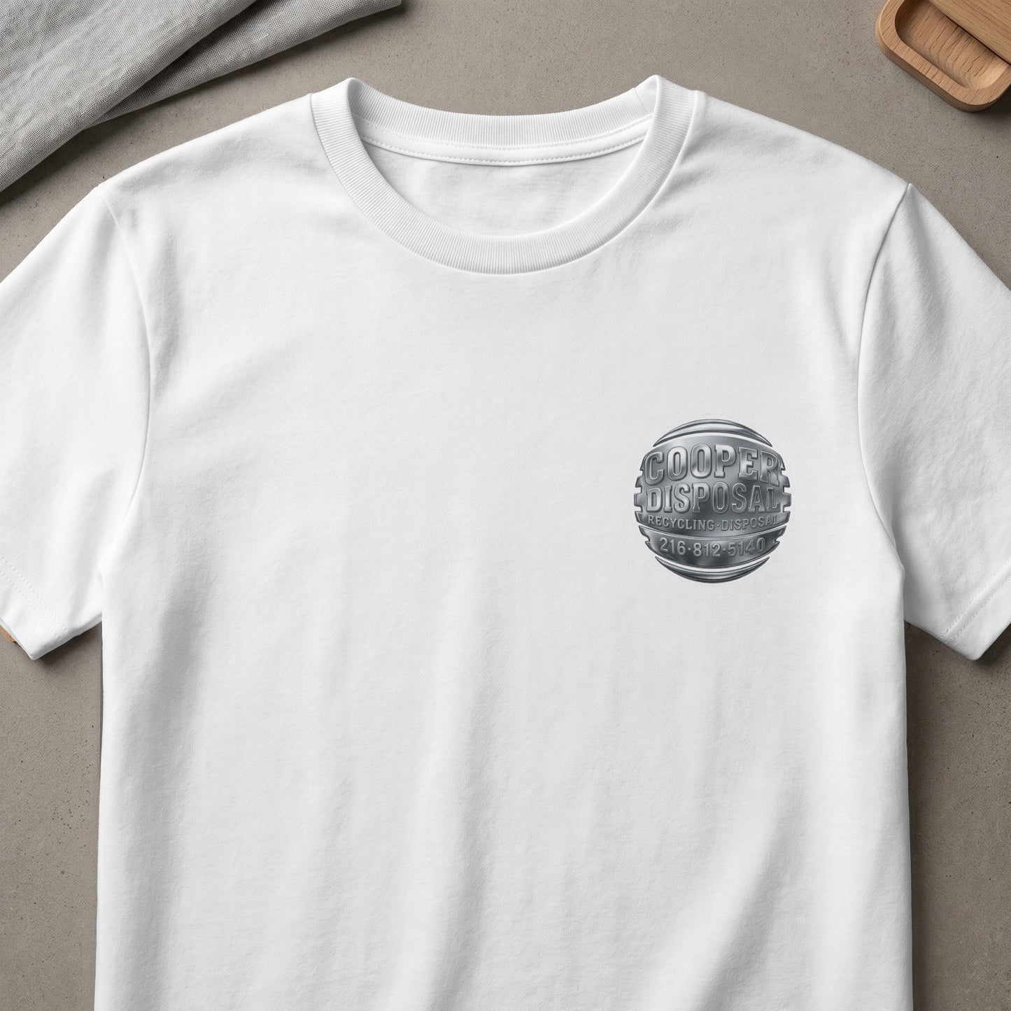 White t-shirt with metallic Cooper Disposal logo and phone number on left chest.