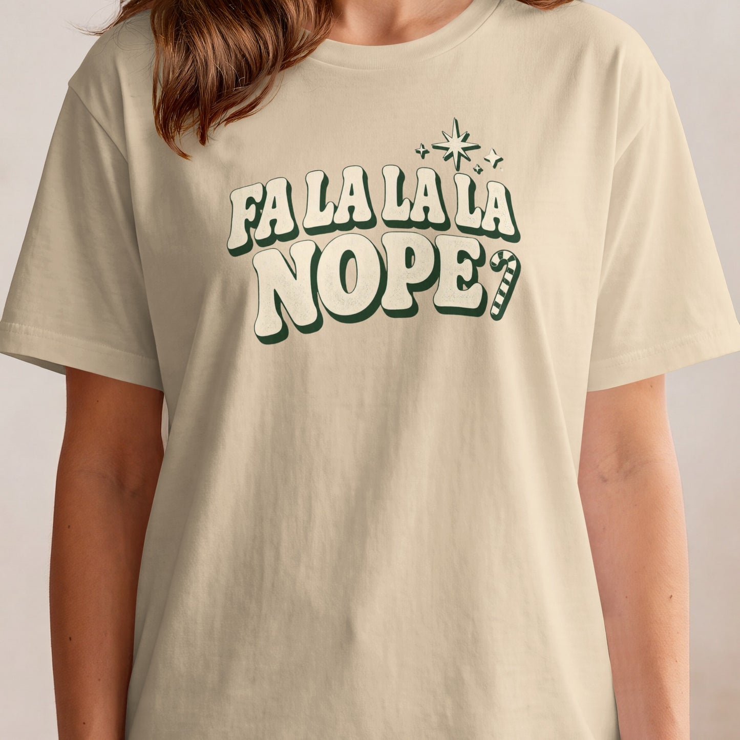 Beige t-shirt with "FA LA LA LA NOPE" in green retro font and candy cane.