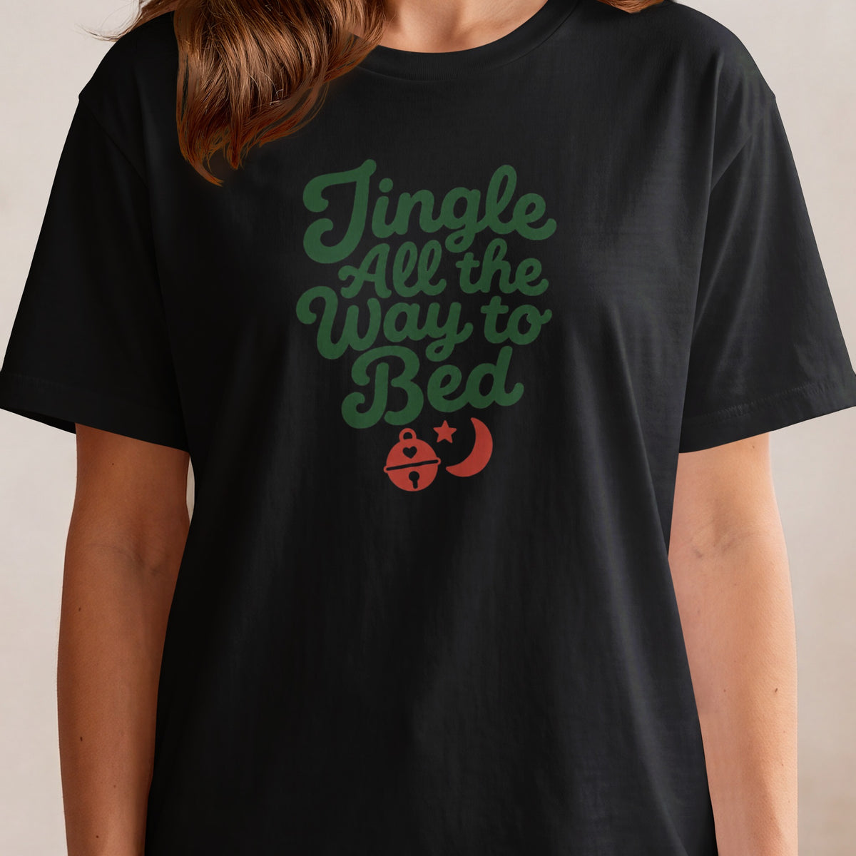 Black t-shirt with green text "Jingle All the Way to Bed" and holiday graphics.