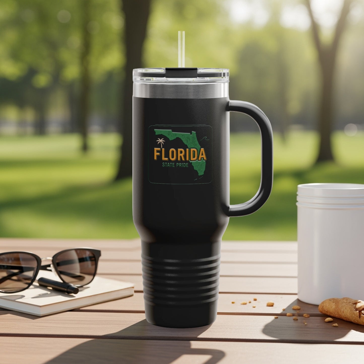 Black tumbler with "Florida State Pride" logo and handle, on a table.