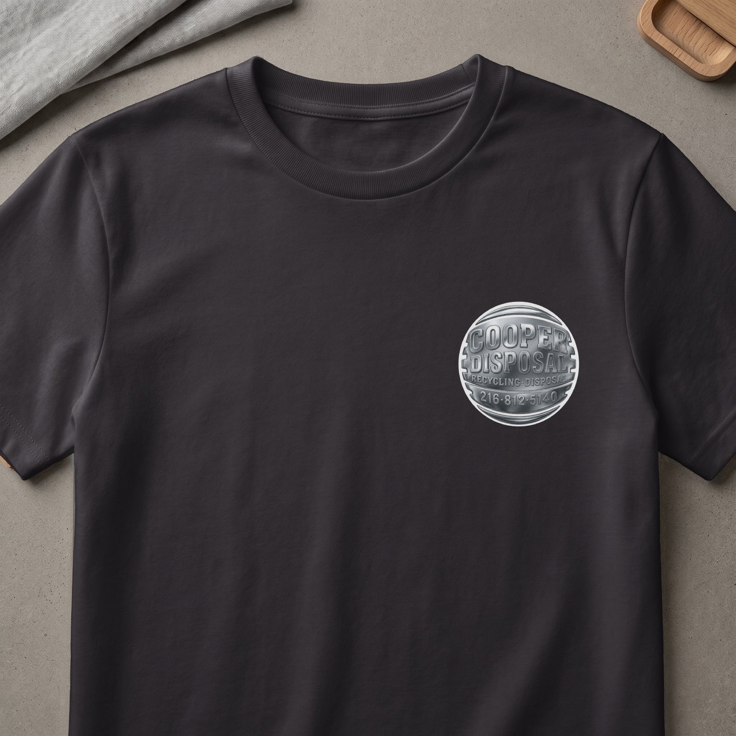 Dark gray t-shirt with metallic silver Cooper Disposal logo and phone number.