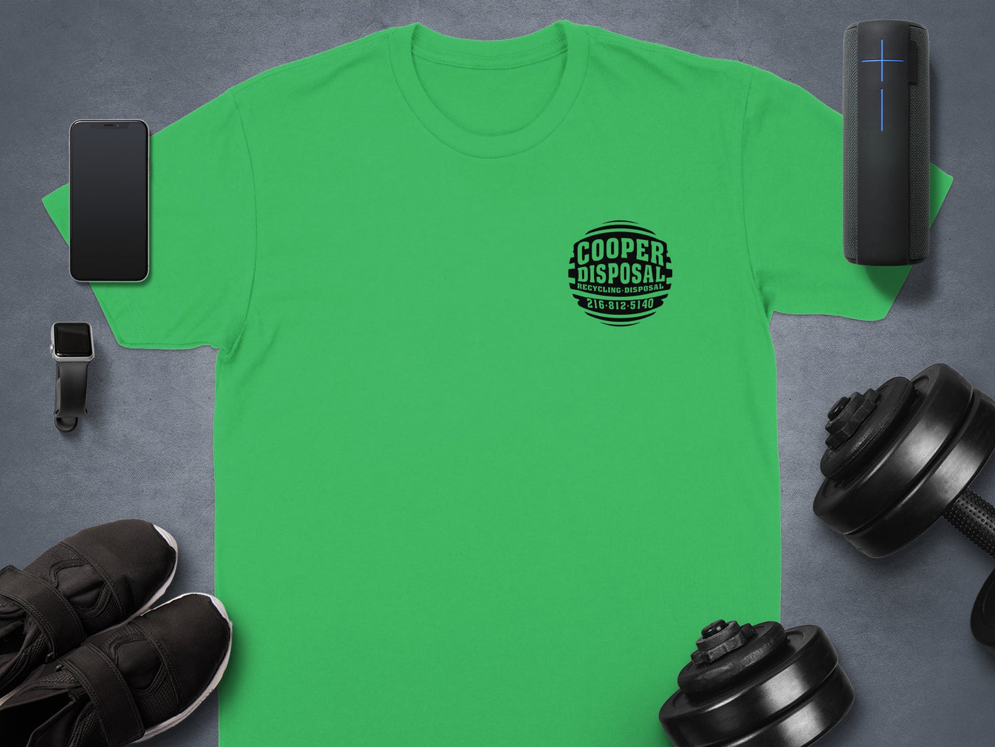 Green t-shirt with Cooper Disposal logo and gym accessories.