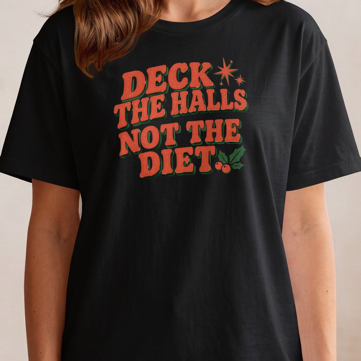 Black t-shirt with text "Deck the Halls Not the Diet" in retro font.