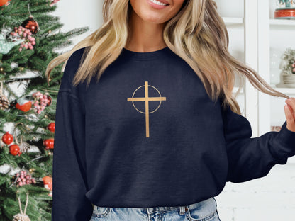 Navy sweatshirt with a gold cross and circle graphic design.