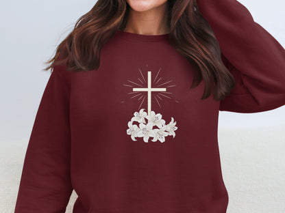 Maroon sweatshirt with a white cross and lilies graphic.