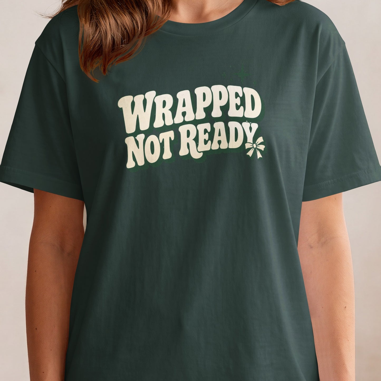 Dark green t-shirt with "WRAPPED NOT READY" text and a green bow.