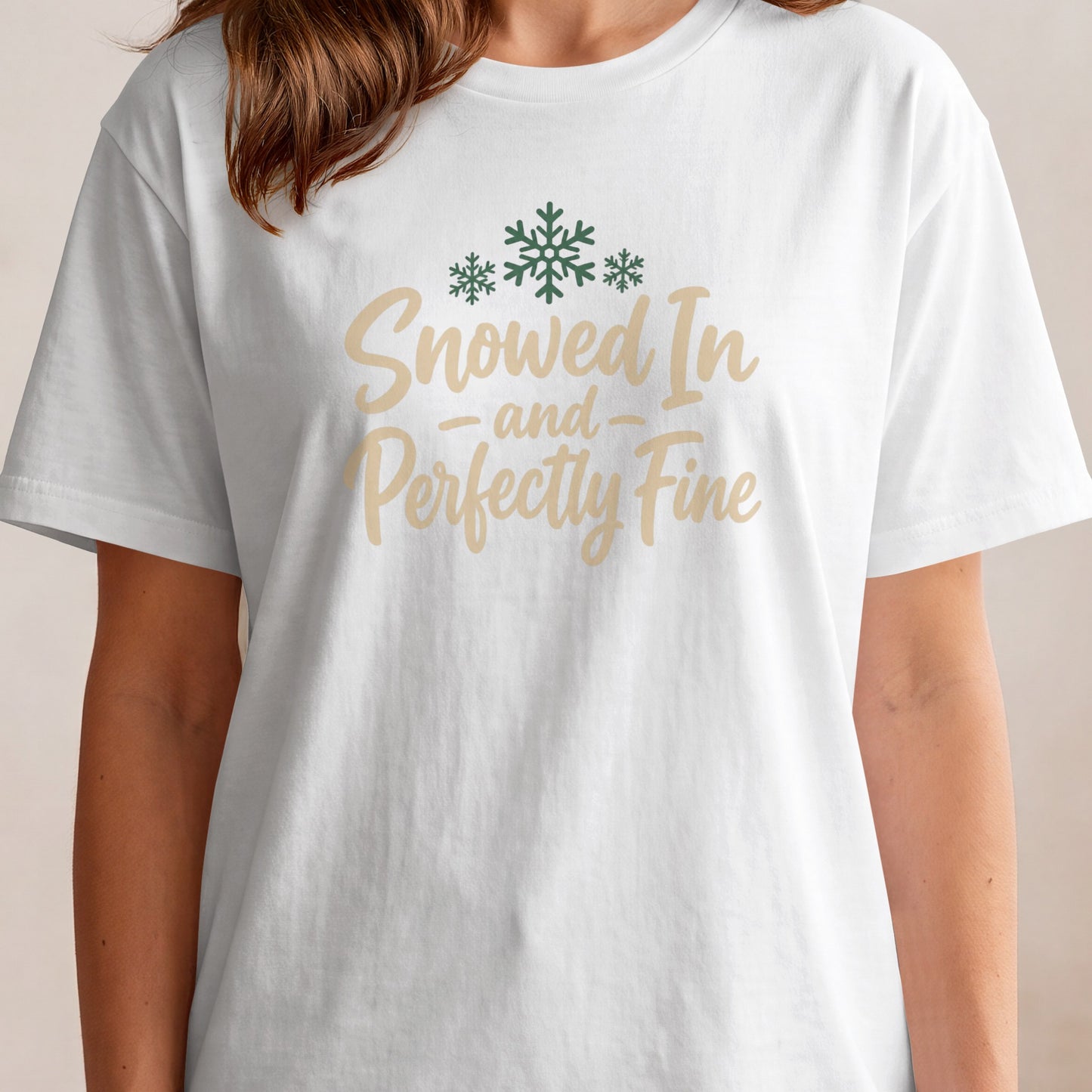 White t-shirt with green snowflakes and text "Snowed In - and - Perfectly Fine".