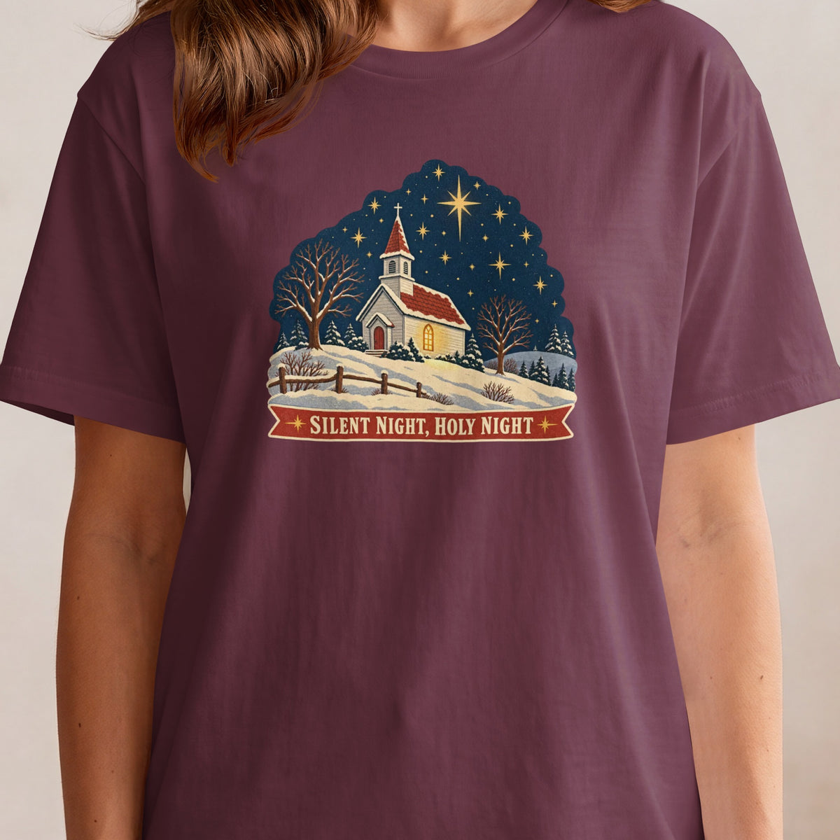 T-shirt with a Christmas scene featuring a church, snowy landscape, and the text "Silent Night, Holy Night."