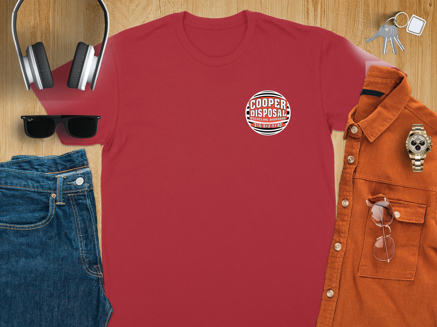 Red t-shirt with Cooper Disposal logo, paired with jeans, sunglasses, and headphones.