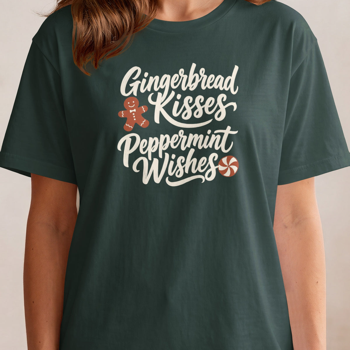 Dark green t-shirt with white text "Gingerbread Kisses Peppermint Wishes", gingerbread man, and peppermint candy.