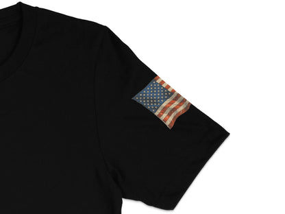 Black t-shirt with a distressed American flag patch on the left sleeve.