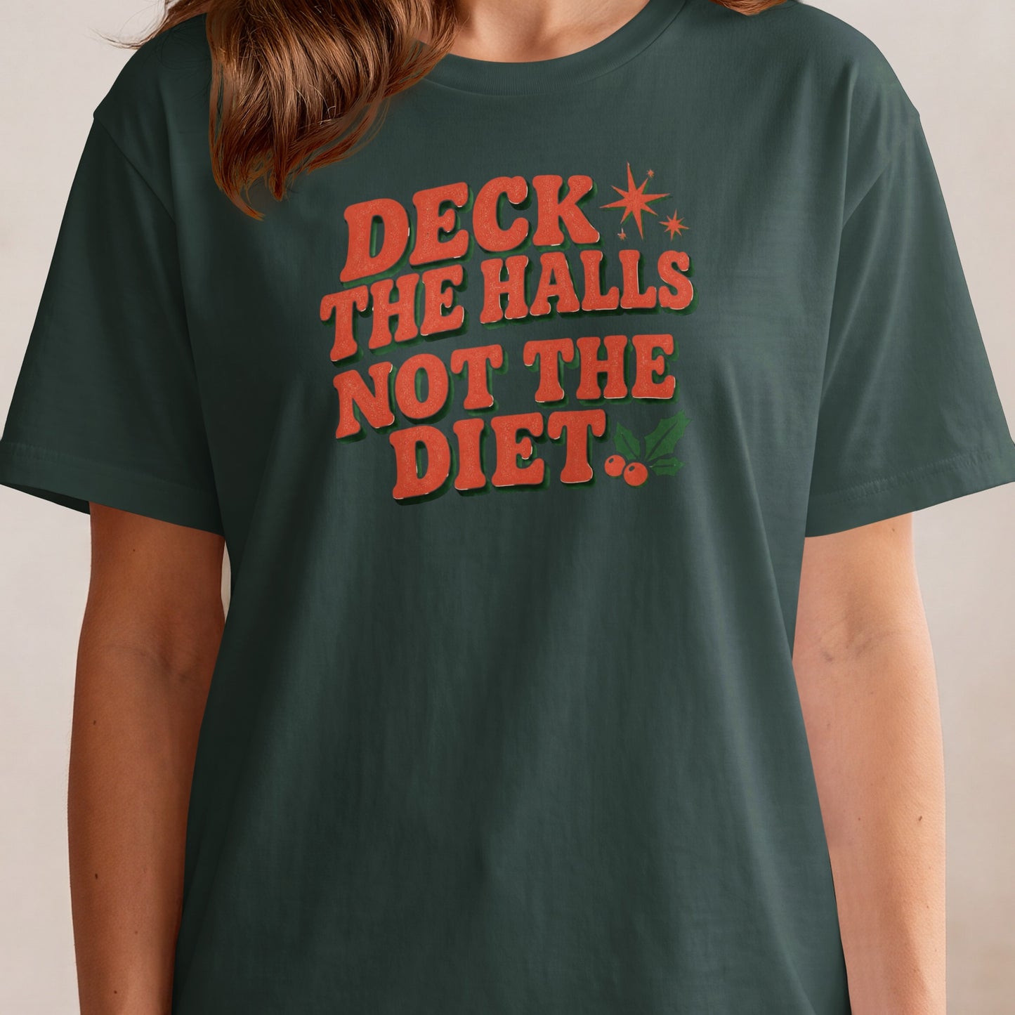 Dark green t-shirt with orange text that reads "DECK THE HALLS NOT THE DIET."