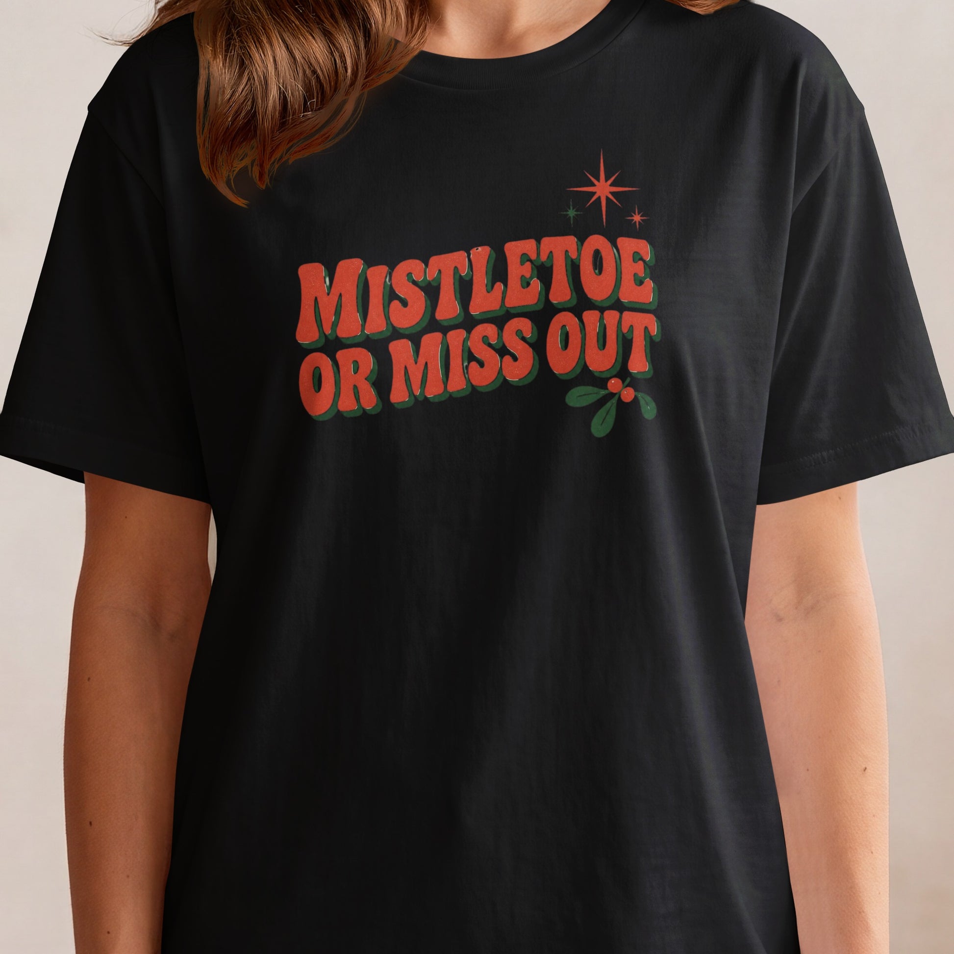 Black t-shirt with "Mistletoe Or Miss Out" text and mistletoe graphic.