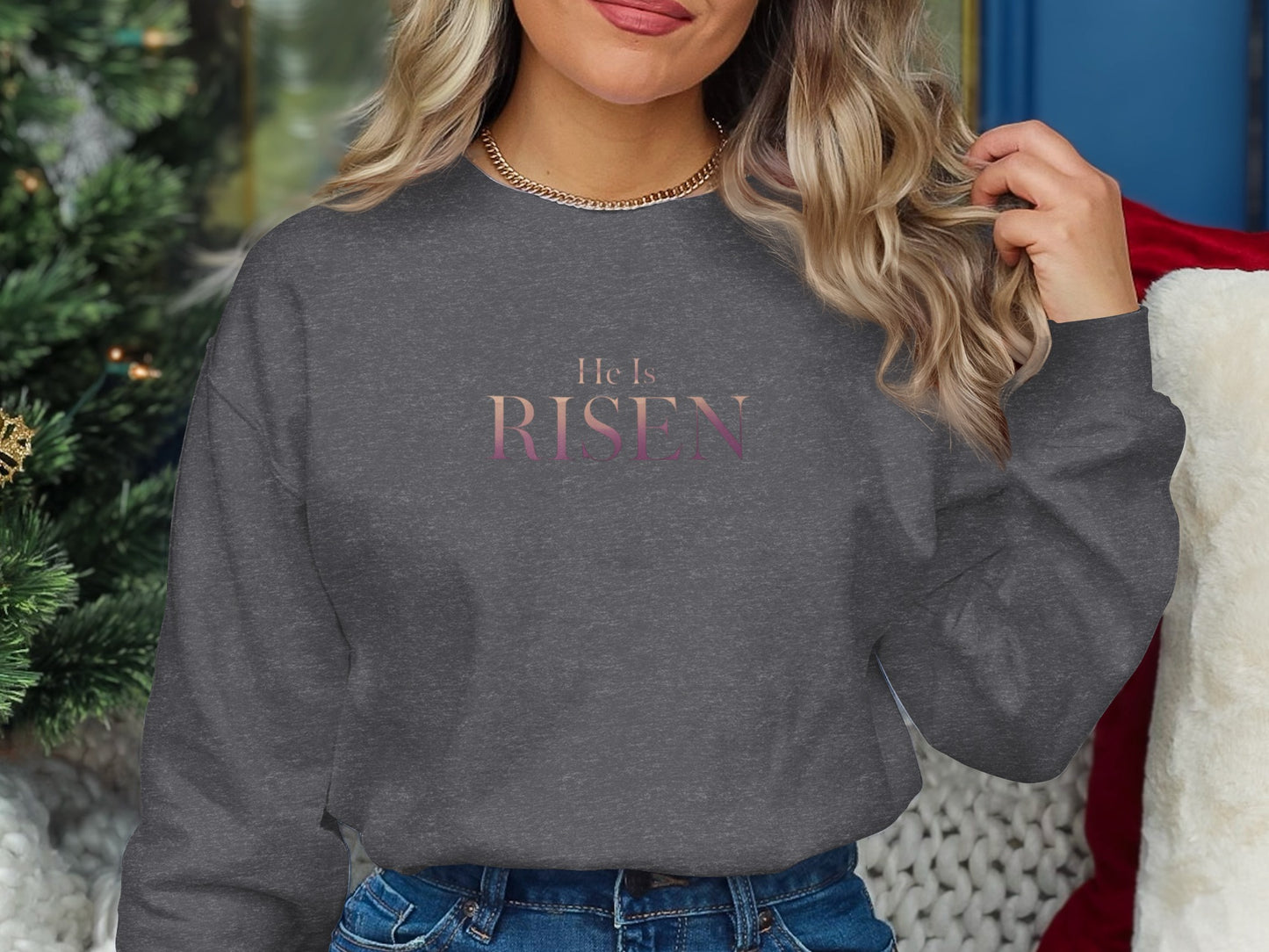 Dark gray sweatshirt with "He Is Risen" text in a gradient of pink and purple.