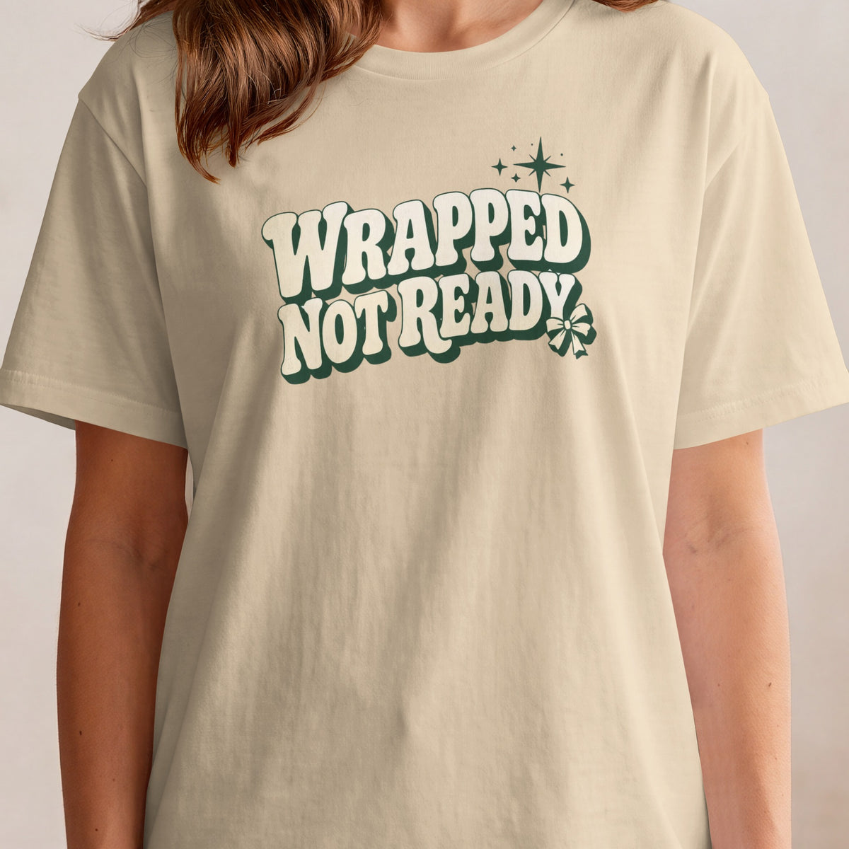 A beige t-shirt with the text "WRAPPED NOT READY" in green with white outlines.