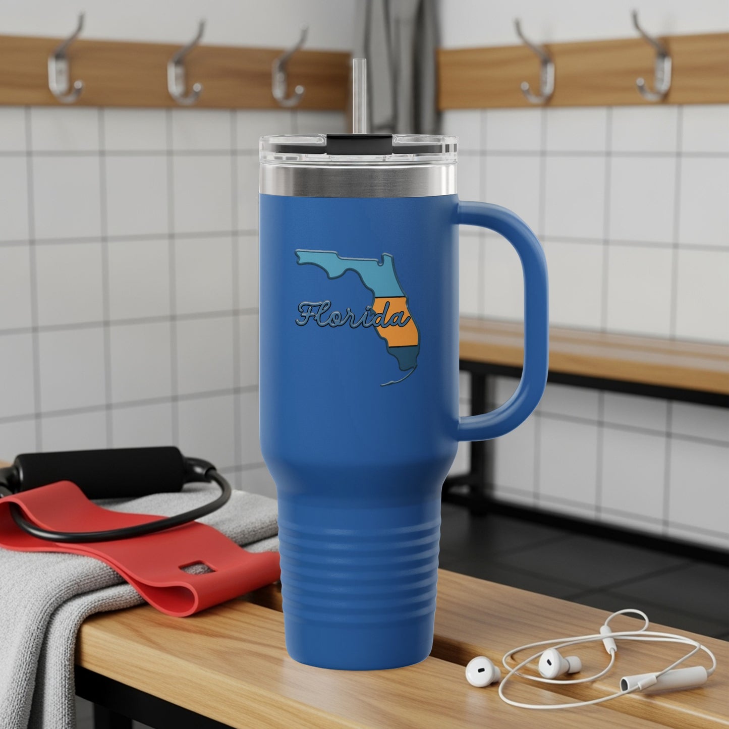 Travel tumbler with Florida Sunshine State logo, outdoors.