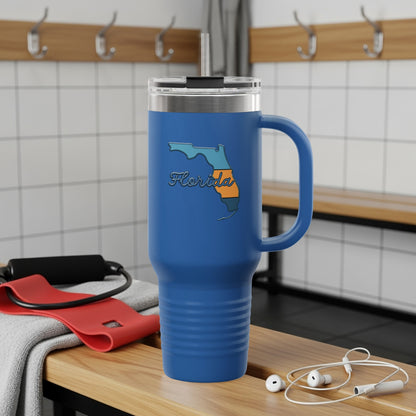 Travel tumbler with Florida Sunshine State logo, outdoors.