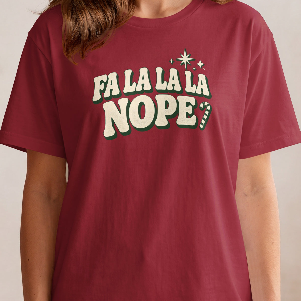 Red t-shirt with "FA LA LA LA NOPE?" and festive accents.