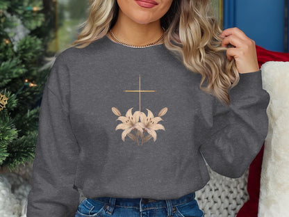 Dark gray sweatshirt featuring a gold cross over two lily flowers.