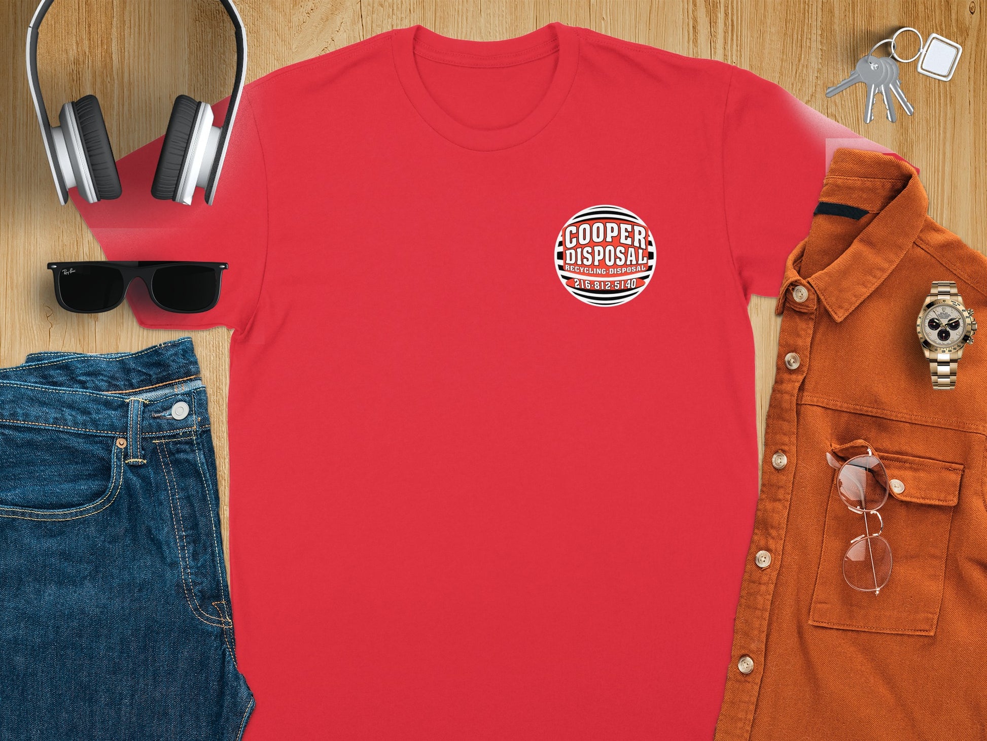 Red t-shirt with Cooper Disposal logo, jeans, shirt, headphones, sunglasses, and watch.