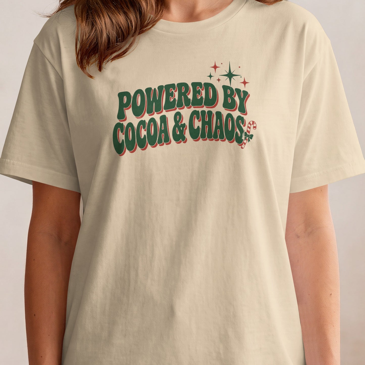 Cream t-shirt with "Powered by Cocoa & Chaos" text and Christmas graphics.