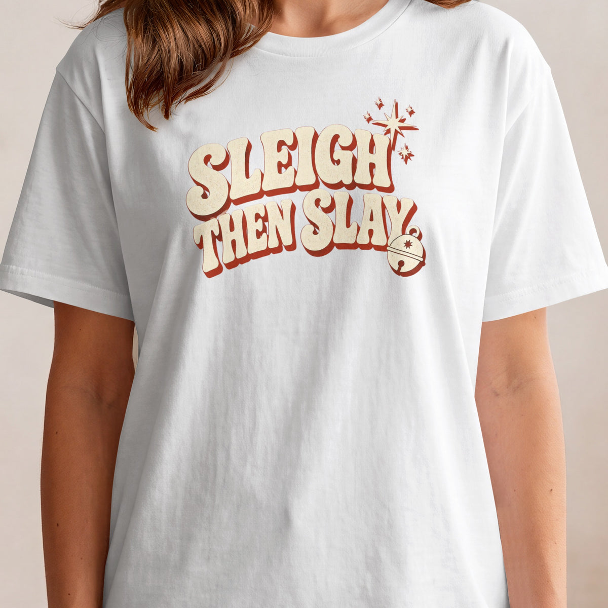 White t-shirt with retro text "Sleigh Then Slay" and festive graphics.