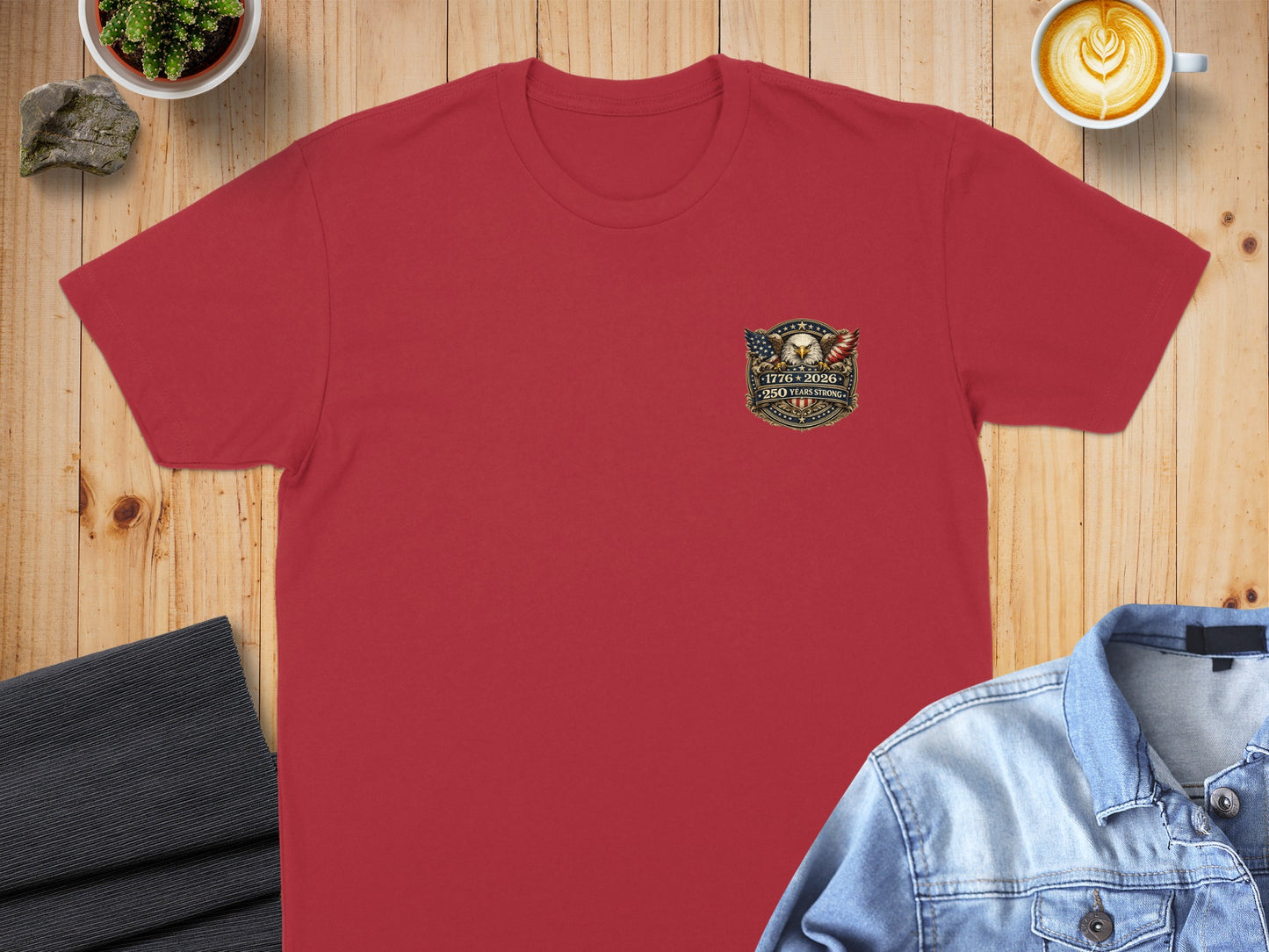 Red t-shirt featuring an emblem with an eagle, flag, and "250 Years" text.
