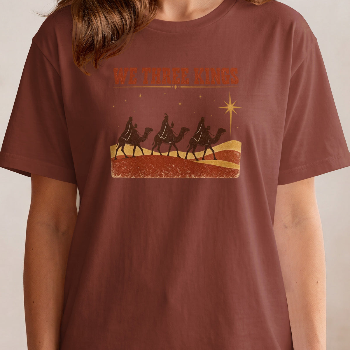 Shirt with "We Three Kings" text and three camels silhouetted against a starry sky.