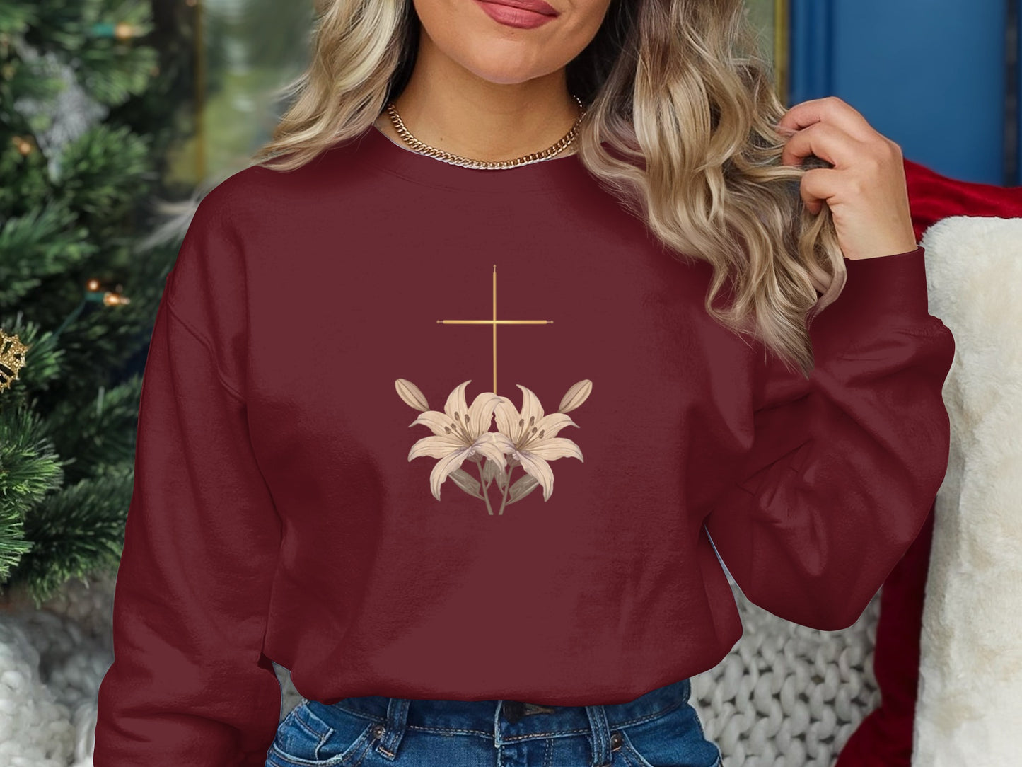 Burgundy sweatshirt with golden cross and lilies design.