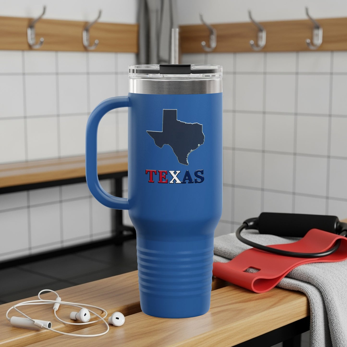 Blue tumbler with Texas outline and "TEXAS" text on a wooden bench.