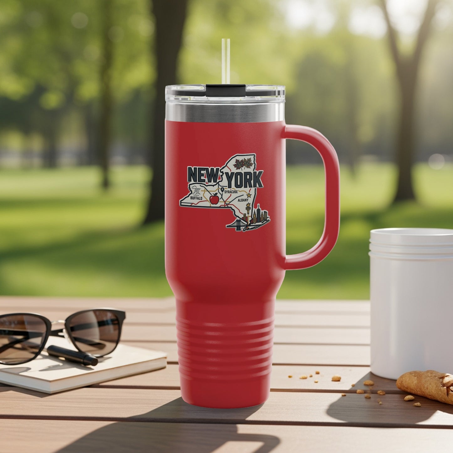 Red tumbler with New York state outline graphic and city names.