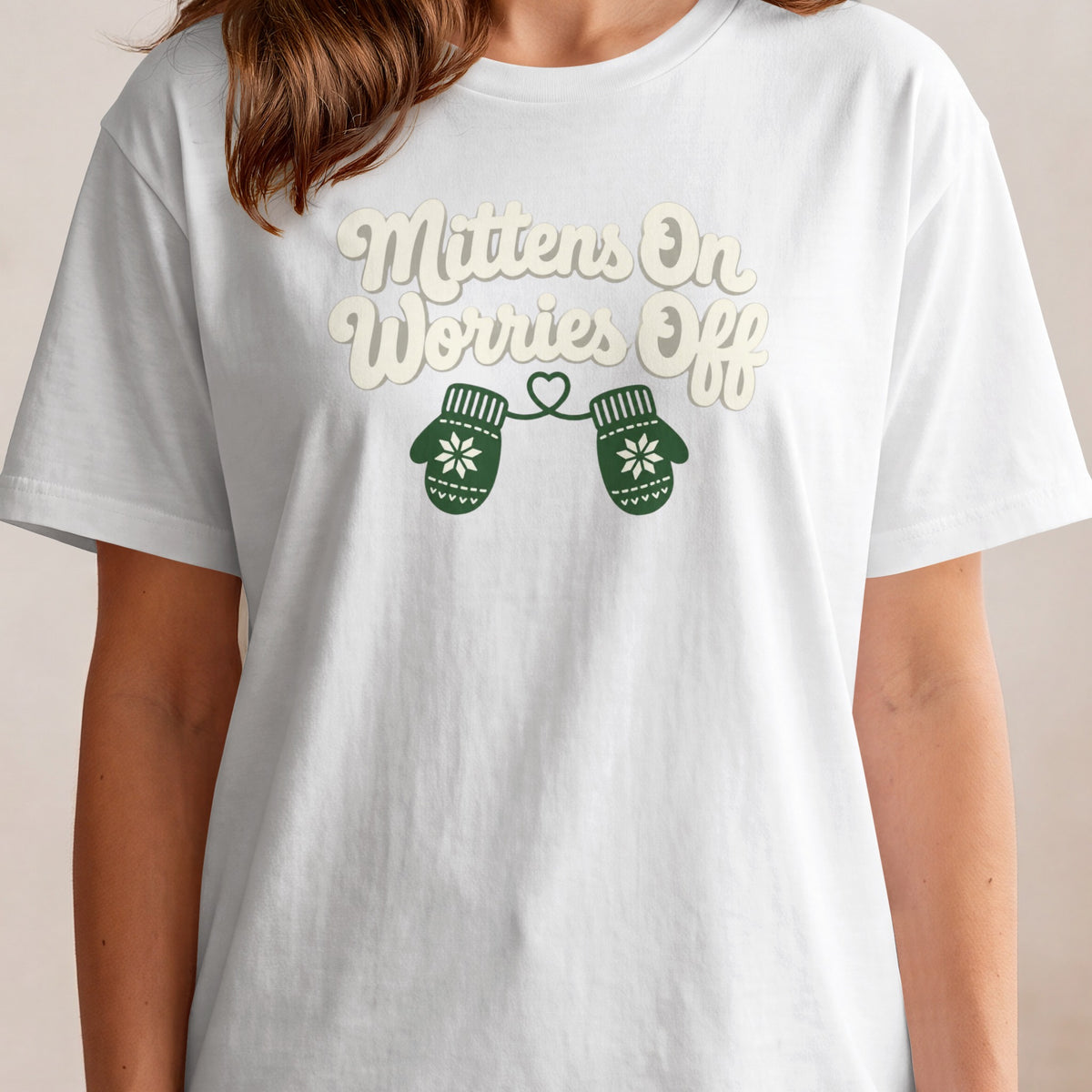 White t-shirt with "Mittens On Worries Off" text and green mittens graphic.