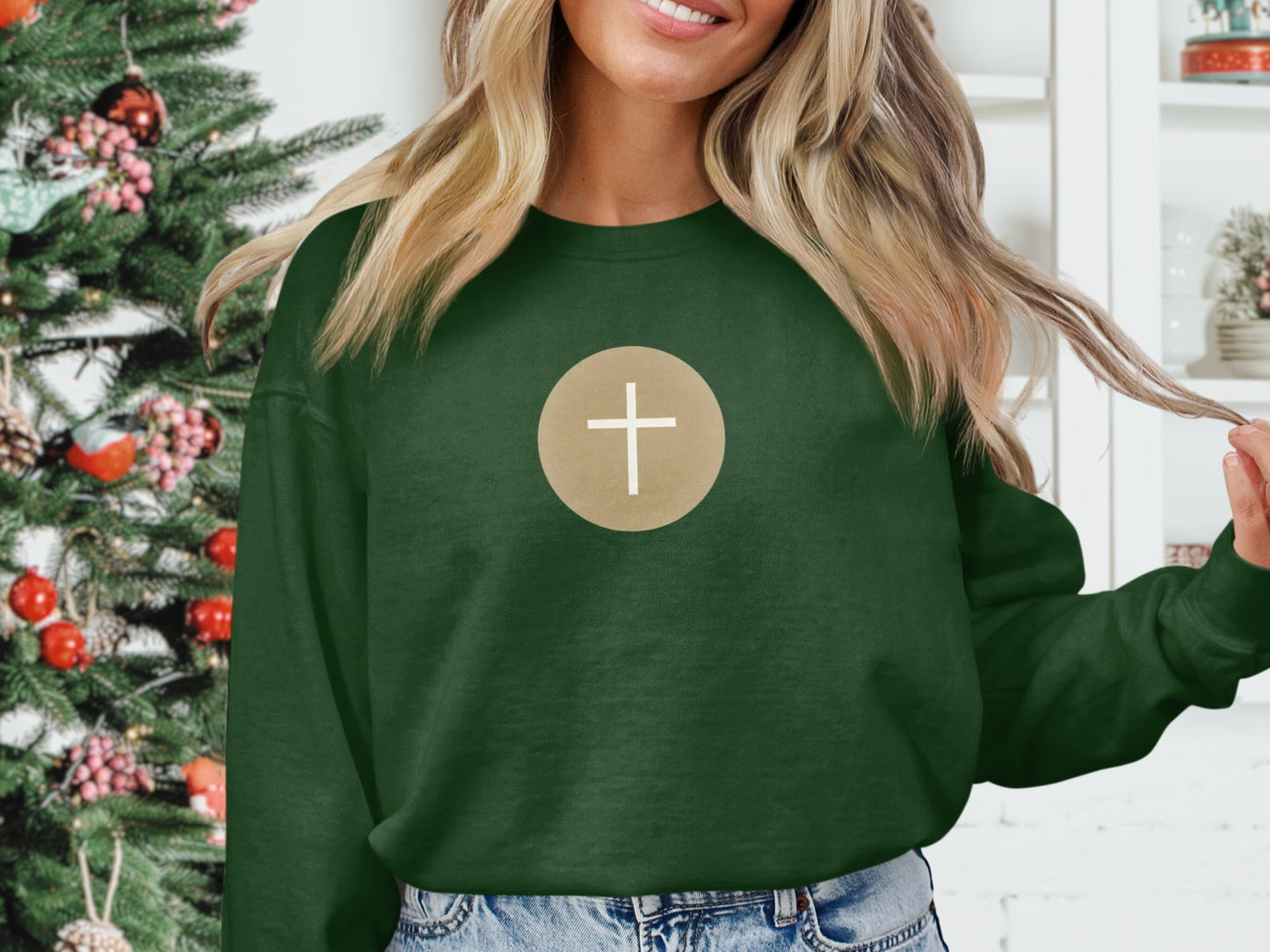 Green sweatshirt with a circular cross emblem on the chest.