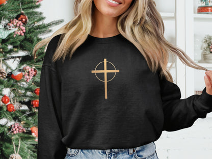 Black crewneck sweatshirt with a gold cross inside a circle graphic.