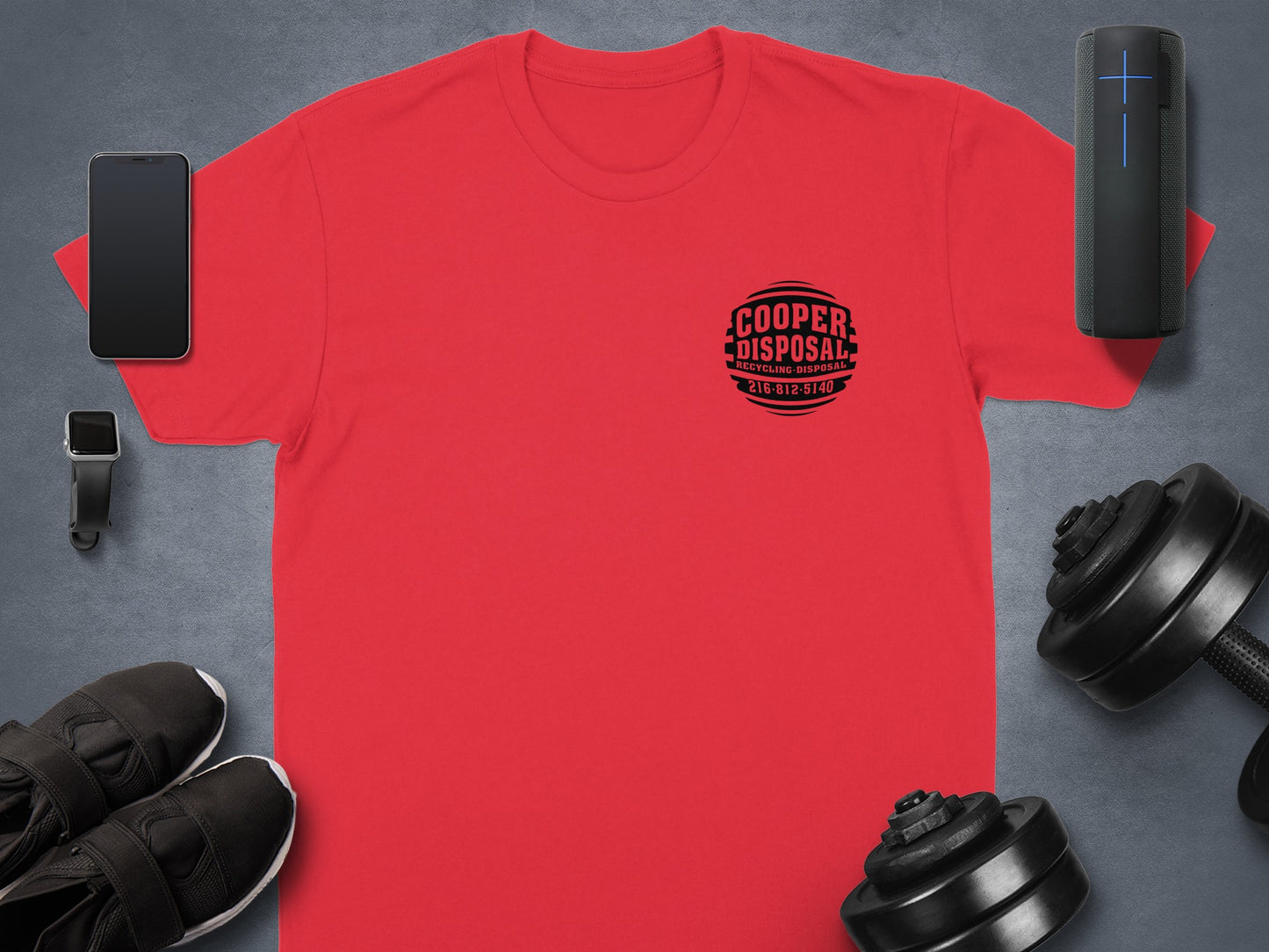 Red t-shirt with "Cooper Disposal" logo and phone, watch, headphones, and dumbbells.