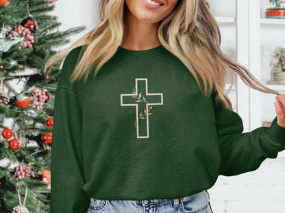 Green crewneck sweatshirt with a cream cross and vine design.