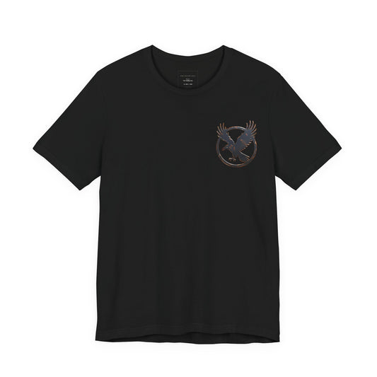 Black t-shirt with a circular raven logo on the left chest.