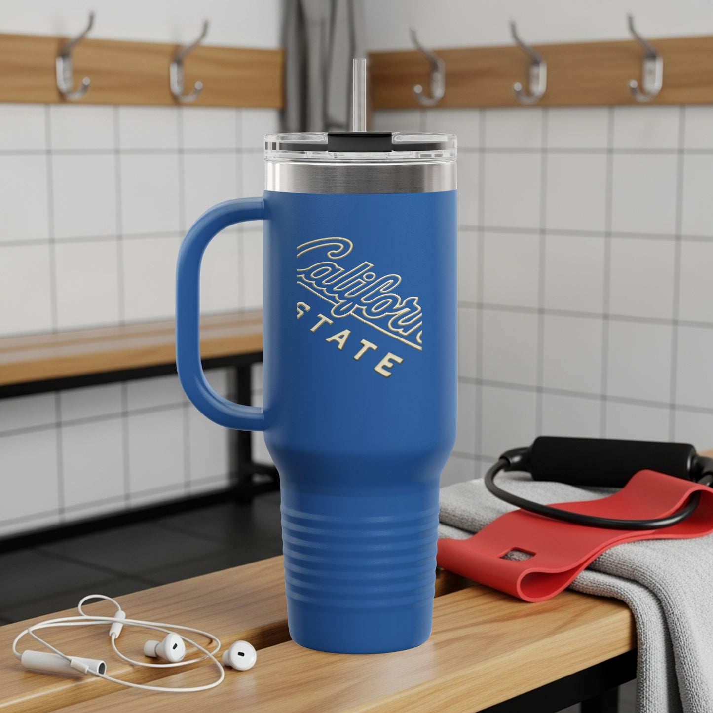 Blue travel tumbler with "California State" logo and handle on a bench.