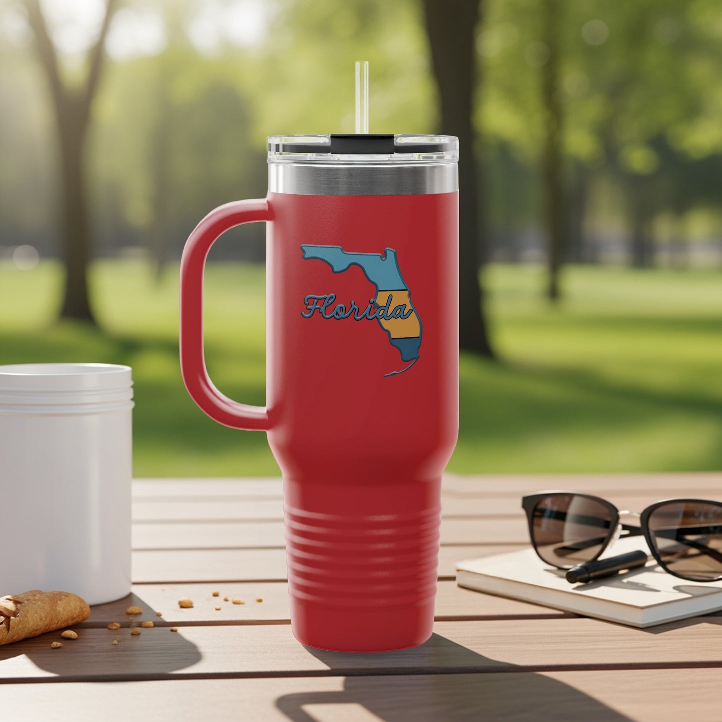 Red travel tumbler with Florida map outline and straw.