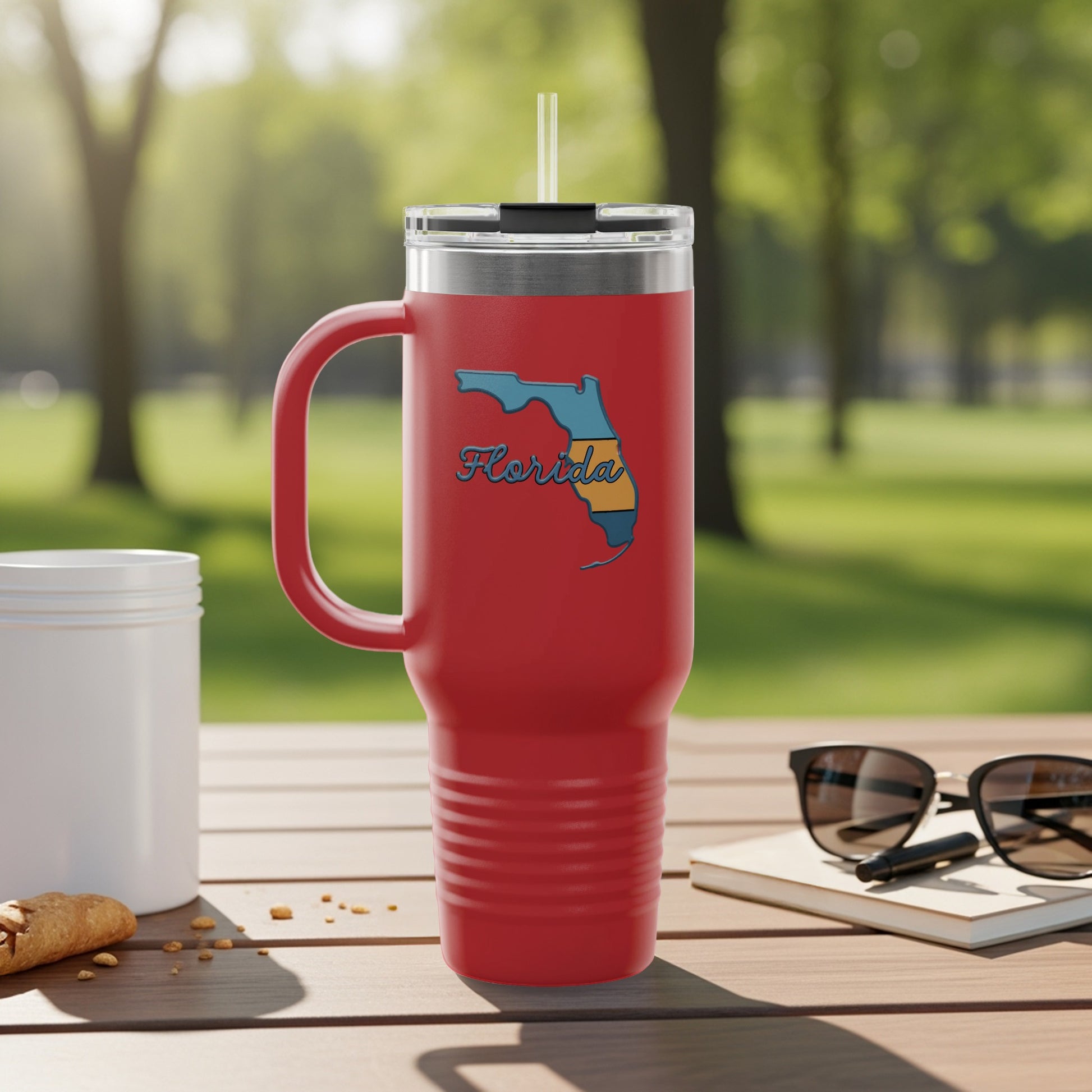 Red travel tumbler with Florida map outline and straw.